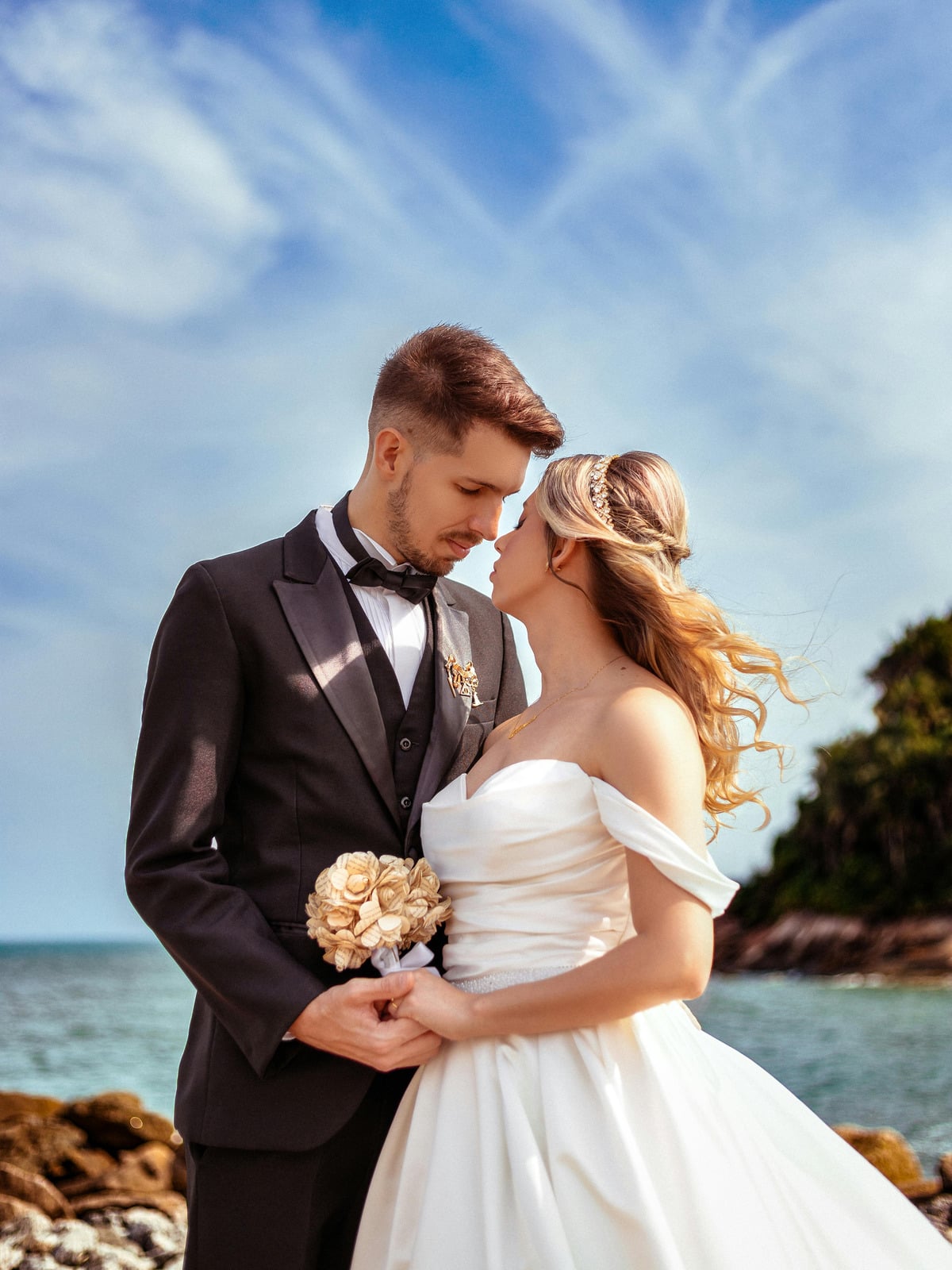 Couple embracing at a beach wedding